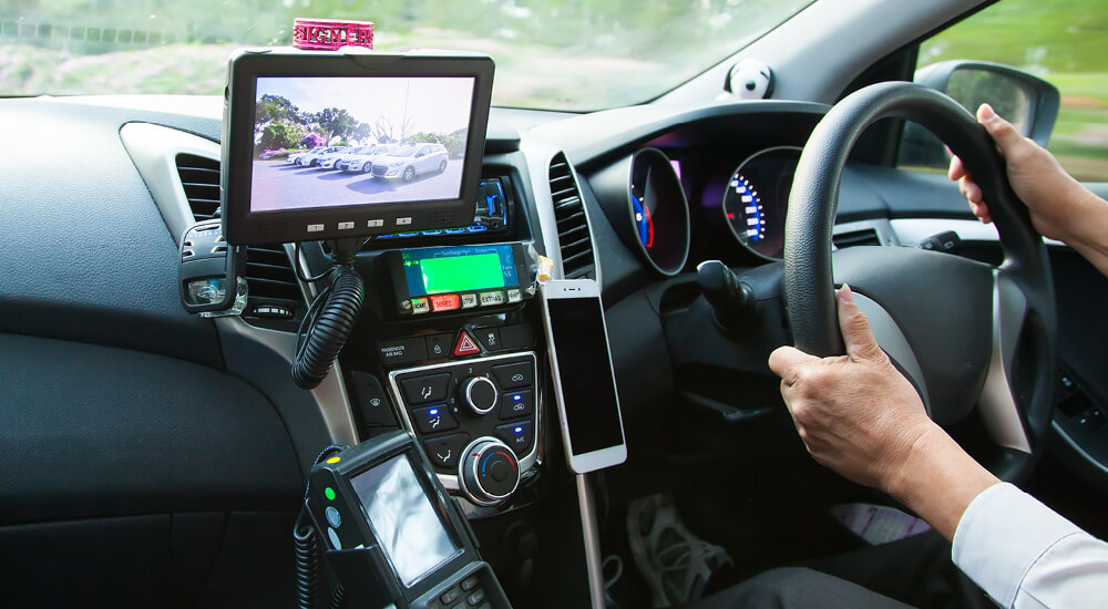 Dashboard and dash-cam view of person driving car
